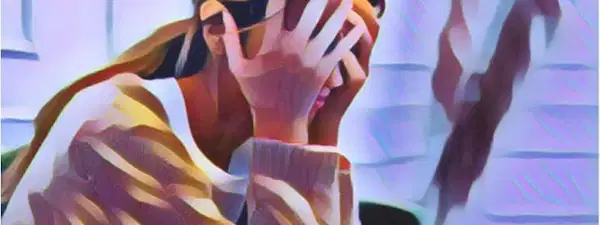 A woman is covering her face with her hands in a motion of despair. Her expression is one of sorrow and sadness, with her lips slightly pursed and her brows furrowed. Her eyes are closed, as if she is trying to shut out the world around her. Her hands, clasped together tightly, are shielding her face from view. Her hair is pulled back into a tight bun, framing her delicate features. The background is blurred, emphasizing her loneliness and despair. She appears to be in a state of deep sorrow, her body language conveying her feelings of anguish and hopelessness.