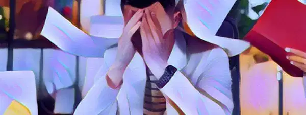 This image shows a man with his hands covering his face. He appears to be frustrated and overwhelmed. His palms are pressed against his brow and his eyes are shut tightly. His mouth is slightly open, revealing the hint of a frown. His expression is full of sadness and melancholy. His head is bowed low, conveying feelings of dejection and despair. His posture is slumped, as if he is weighed down by his thoughts. The man sits in a dimly lit room with a plain white wall behind him. The atmosphere is somber and oppressive. His despondency is palpable in this moment, and he appears to be struggling with a difficult emotion.